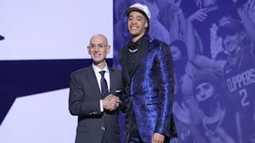 Penn State's Yanic Konan Niederhauser stands with NBA commissioner Adam Silver after being selected as the 30th pick by the Los Angeles Clippers in the first round of the 2025 NBA Draft. 