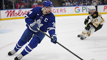 Jan 4, 2025; Toronto, Ontario, CAN; Toronto Maple Leafs forward Auston Matthews (34) carries the puck as Boston Bruins forward Brad Marchand (63) closes in during the second period at Scotiabank Arena. Mandatory Credit: John E. Sokolowski-Imagn Images