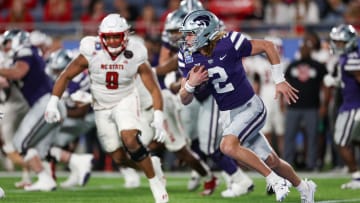 Dec 28, 2023; Orlando, FL, USA;  Kansas State Wildcats quarterback Avery Johnson (2) runs with the ball against the North Carolina State Wolfpack in the first quarter during the Pop-Tarts bowl at Camping World Stadium. Mandatory Credit: Nathan Ray Seebeck-USA TODAY Sports