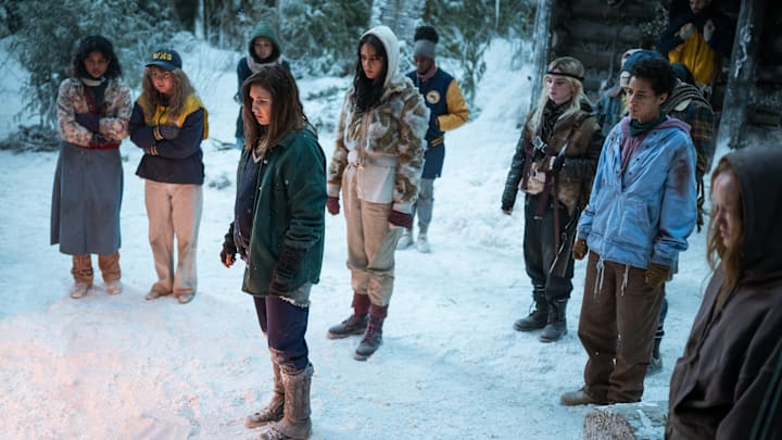 (L-R): Nuha Jes Izman as Teen Crystal, Samantha Hanratty as Teen Misty, Alexa Barajas as Teen Mari, Sophie Nélisse as Teen Shauna, Courtney Eaton as Teen Lottie, Nia Sondaya as Teen Akilah, Sophie Thatcher as Teen Natalie, Jasmin Savoy Brown as Teen Taissa, Steven Krueger as Ben Scott and Liv Hewson as Teen Van in YELLOWJACKETS, Season 2. Photo Credit: Kailey Schwerman/SHOWTIME.