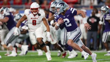 Dec 28, 2023; Orlando, FL, USA;  Kansas State Wildcats quarterback Avery Johnson (2) runs with the ball against the North Carolina State Wolfpack in the first quarter during the Pop-Tarts Bowl at Camping World Stadium. Mandatory Credit: Nathan Ray Seebeck-USA TODAY Sports