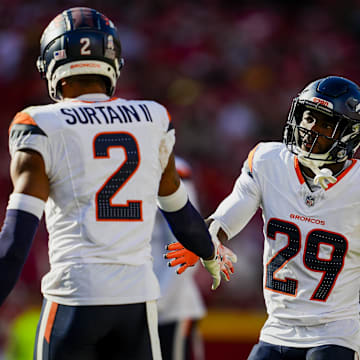 Nov 10, 2024; Kansas City, Missouri, USA; Denver Broncos cornerback Ja'Quan McMillian (29) celebrates with cornerback Pat Surtain II (2) after a play during the second half against the Kansas City Chiefs at GEHA Field at Arrowhead Stadium. 