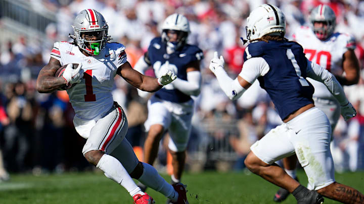 Ohio State Buckeyes running back Quinshon Judkins (1) runs around Penn State Nittany Lions safety Jaylen Reed (1) 
