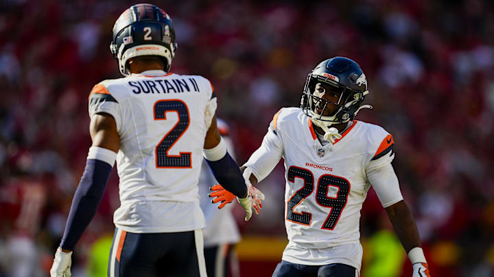 Nov 10, 2024; Kansas City, Missouri, USA; Denver Broncos cornerback Ja'Quan McMillian (29) celebrates with cornerback Pat Surtain II (2) after a play during the second half against the Kansas City Chiefs at GEHA Field at Arrowhead Stadium. 