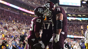 Oct 25, 2025; Baton Rouge, Louisiana, USA; Texas A&M Aggies running back Jamarion Morrow (23) celebrates with offensive lineman Chase Bisontis (71) and tight end Theo Melin Ohrstrom (17) after a touchdown during the second half against the Louisiana State Tigers at Tiger Stadium. Mandatory Credit: Stephen Lew-Imagn Images