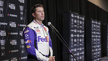 Sep 4, 2024; Charlotte, North Carolina, USA; Denny Hamlin speaks to media members during the NASCAR Playoffs Media Day at the Charlotte Convention Center. 