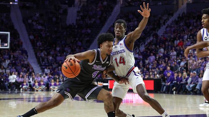 Kansas State Wildcats guard P.J. Haggerty (4) is guarded by Kansas Jayhawks guard Melvin Council Jr. (14)