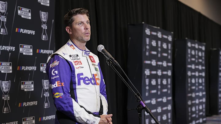 Sep 4, 2024; Charlotte, North Carolina, USA; Denny Hamlin speaks to media members during the NASCAR Playoffs Media Day at the Charlotte Convention Center. 