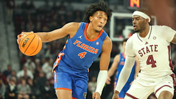 Florida Gators forward Sam Alexis (4) drives against Mississippi State Bulldogs forward Cameron Matthews (4) during the first half at Humphrey Coliseum.