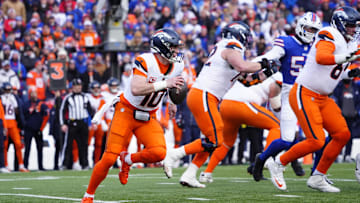 Jan 12, 2025; Orchard Park, New York, USA; Denver Broncos quarterback Bo Nix (10) runs out of the pocket during the second quarter against the Buffalo Bills in an AFC wild card game at Highmark Stadium. Mandatory Credit: Gregory Fisher-Imagn Images