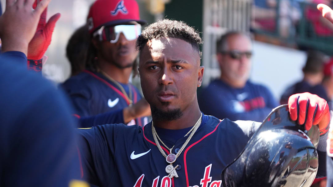 Mar 24, 2025; Mesa, Arizona, USA; Atlanta Braves second base Ozzie Albies (1) celebrates with teammates after scoring against the Chicago Cubs in the second inning at Sloan Park. Mandatory Credit: Rick Scuteri-Imagn Images