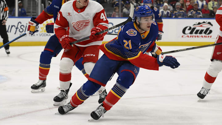 Apr 1, 2025; St. Louis, Missouri, USA; St. Louis Blues right wing Jimmy Snuggerud (21) skates against Detroit Red Wings right wing Jonatan Berggren (48) during the first period at Enterprise Center. Mandatory Credit: Jeff Le-Imagn Images