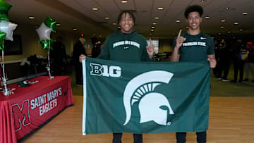 From left, Charles White and Jayden Savoury show off their pride after signing to play football with Michigan State University at Orchard Lake St. Mary’s Preparatory in Orchard Lake on Wednesday, Dec. 4, 2024.
