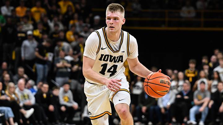 Mar 5, 2026; Iowa City, Iowa, USA; Iowa Hawkeyes guard Bennett Stirtz (14) controls the ball as Michigan Wolverines guard Trey McKenney (1) defends during the second half at Carver-Hawkeye Arena. Mandatory Credit: Jeffrey Becker-Imagn Images