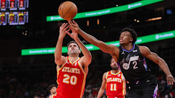 Atlanta Hawks forward Georges Niang (20) and Utah Jazz guard Collin Sexton (2) reach for a loose ball in the third quarter at State Farm Arena.
