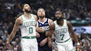 Tatum and Brown look for a rebound against Mavericks guard Klay Thompson.