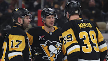 Dec 9, 2025; Pittsburgh, Pennsylvania, USA;  Pittsburgh Penguins right wing Bryan Rust (17) and center Sidney Crosby (87) and right wing Anthony Mantha (39) talk on the ice against the Anaheim Ducks during the second period at PPG Paints Arena. Mandatory Credit: Charles LeClaire-Imagn Images