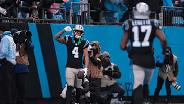 Nov 30, 2025; Charlotte, North Carolina, USA; Carolina Panthers wide receiver Tetairoa McMillan (4) celebrates after scoring a touchdown during the fourth quarter against the Los Angeles Rams at Bank of America Stadium. Mandatory Credit: Scott Kinser-Imagn Images
