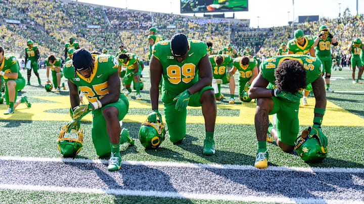 Shown here before the Idaho game, Oregon Ducks defensive back Ify Obidegwu (25) defensive lineman Terrance Green (99) and Oregon Ducks linebacker Jerry Mixon (54)  have to include teammates Trey McNutt and Jurrion Dickey in their prayers.