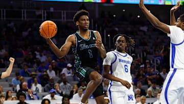 Mar 15, 2025; Fort Worth, TX, USA; Tulane Green Wave forward Kaleb Banks (1) passes the ball ahead of Memphis Tigers guard Baraka Okojie (6) during the first half at Dickies Arena.