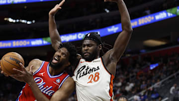 Feb 7, 2025; Detroit, Michigan, USA;  Philadelphia 76ers center Joel Embiid (21) is defended by Detroit Pistons center Isaiah Stewart (28): Rick Osentoski-Imagn Images