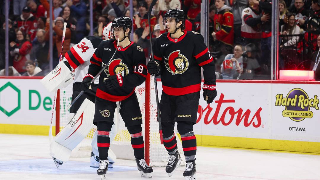 Ottawa Senators forwards Tim Stützle and Dylan Cozens celebrating after a goal during a game January 31 vs New Jersey Devils when both players were on the scoresheet
