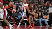 Apr 4, 2025; Toronto, Ontario, CAN;  Toronto Raptors guard Ja'Kobe Walter (14) controls the ball in front of Detroit Pistons forward Ron Halland II (00) in the first half at Scotiabank Arena. Mandatory Credit: Dan Hamilton-Imagn Images