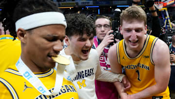 Michigan Wolverines players react after they defeat the Wisconsin Badgers during the 2025 TIAA Big Ten Men’s Basketball Tournament final game on Sunday, March 16, 2025, at Gainbridge Fieldhouse in Indianapolis. Michigan defeated Wisconsin 59-53.
