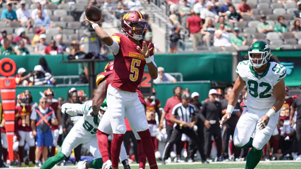 Aug 10, 2024; East Rutherford, New Jersey, USA; Washington Commanders quarterback Jayden Daniels (5) throws a pass during the