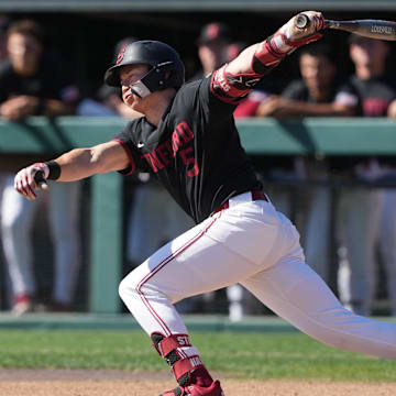 Mar 1, 2025; Stanford, CA, USA; Stanford Cardinal third baseman Trevor Haskins (5) hits a single against the Xavier Musketeers during the first inning at Sunken Diamond. Mandatory Credit: Darren Yamashita-Imagn Images