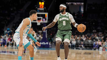 Milwaukee Bucks forward Bobby Portis handles the ball against Charlotte Hornets guard Josh Green during the first half at Spectrum Center on Wednesday.