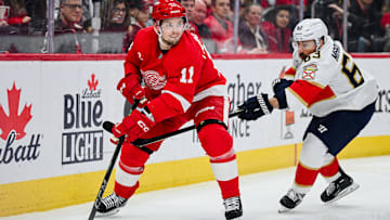 Apr 6, 2025; Detroit, Michigan, USA; Detroit Red Wings right wing Vladimir Tarasenko (11) and Florida Panthers center Brad Marchand (63) battle for the puck during the second period at Little Caesars Arena. Mandatory Credit: Tim Fuller-Imagn Images