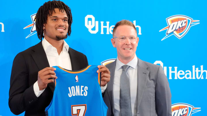 Dillon Jones stands with Thunder general manager Sam Presti during an introductory press conference for the 2024 Thunder draft picks at Oklahoma Conte