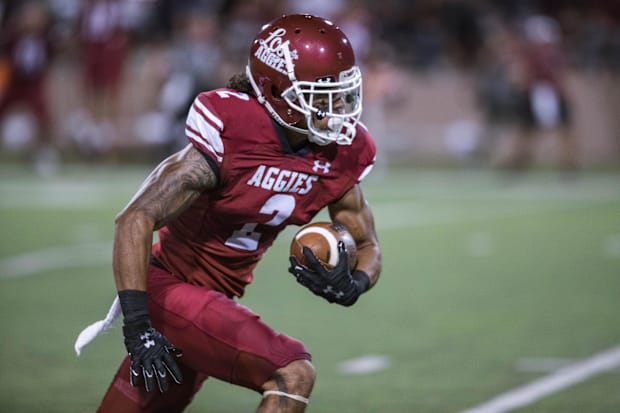 Isaiah Garcia-Castaneda (2) receives and runs the ball as the New Mexico State Aggies face off against the UTEP Miners.