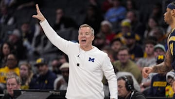 Dec 18, 2024; Charlotte, North Carolina, USA; Michigan Wolverines head coach Dusty May yells to his team during the first half against the Oklahoma Sooners at Spectrum Center. Mandatory Credit: Jim Dedmon-Imagn Images
