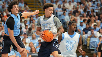 Oct 4, 2025; Charlotte, NC, USA; North Carolina Tar Heels guard Kyan Evans (0) grabs a rebound as forward Zayden High (1) defends in the second half at Dean E. Smith Center. Mandatory Credit: Bob Donnan-Imagn Images