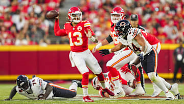 Aug 22, 2024; Kansas City, Missouri, USA; Kansas City Chiefs quarterback Chris Oladokun (13) throws a pass against Chicago Bears defensive tackle Michael Dwumfour (78) and defensive lineman Austin Booker (94) during the first half at GEHA Field at Arrowhead Stadium. Mandatory Credit: Jay Biggerstaff-Imagn Images