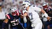 Buffalo Bills QB Josh Allen rushes the ball past New England Patriots linebacker Christian Elliss.