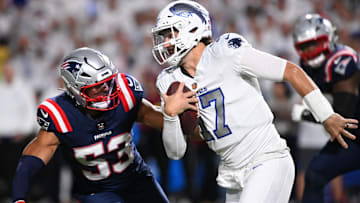 Buffalo Bills QB Josh Allen rushes the ball past New England Patriots linebacker Christian Elliss.