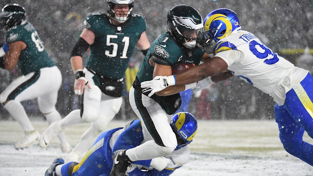 Jan 19, 2025; Philadelphia, Pennsylvania, USA; Philadelphia Eagles quarterback Jalen Hurts (1) is sacked  by Los Angeles Rams defensive tackle Neville Gallimore (92) and Rams linebacker Keir Thomas (96) in the end zone for a safety during the third quarter in a 2025 NFC divisional round game at Lincoln Financial Field. Mandatory Credit: Eric Hartline-Imagn Images