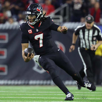 Jan 11, 2025; Houston, Texas, USA; Houston Texans quarterback C.J. Stroud (7) runs the ball during the third quarter against the Los Angeles Chargers in an AFC wild card game at NRG Stadium. Mandatory Credit: Troy Taormina-Imagn Images