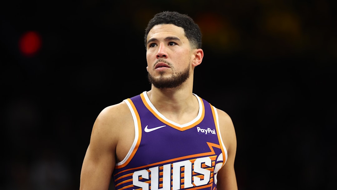Dec 18, 2025; Phoenix, Arizona, USA; Phoenix Suns guard Devin Booker (1) against the Golden State Warriors at Mortgage Matchup Center. Mandatory Credit: Mark J. Rebilas-Imagn Images
