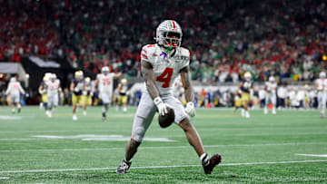 Jan 20, 2025; Atlanta, GA, USA; Ohio State Buckeyes wide receiver Jeremiah Smith (4) reacts after making a catch against the Notre Dame Fighting Irish during the CFP National Championship.