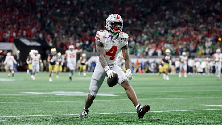 Jan 20, 2025; Atlanta, GA, USA; Ohio State Buckeyes wide receiver Jeremiah Smith (4) reacts after making a catch against the Notre Dame Fighting Irish during the CFP National Championship.