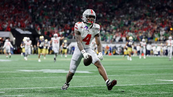 Jan 20, 2025; Atlanta, GA, USA; Ohio State Buckeyes wide receiver Jeremiah Smith (4) reacts after making a catch against the Notre Dame Fighting Irish during the second half the CFP National Championship college football game at Mercedes-Benz Stadium. Mandatory Credit: Mark J. Rebilas-Imagn Images
