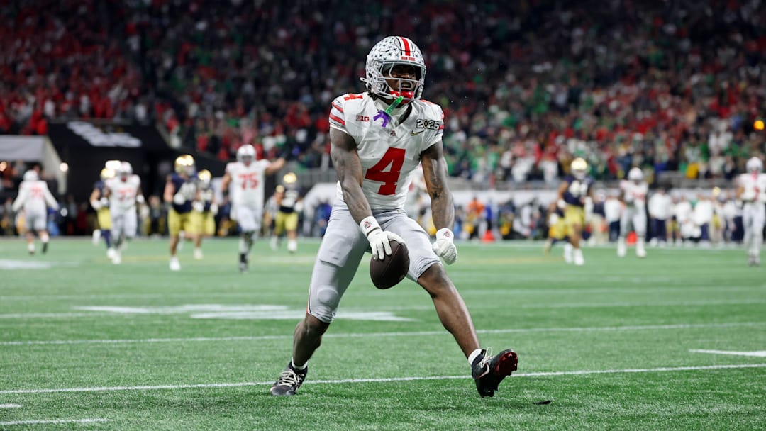 Jan 20, 2025; Atlanta, GA, USA; Ohio State Buckeyes wide receiver Jeremiah Smith (4) reacts after making a catch against the Notre Dame Fighting Irish during the second half the CFP National Championship college football game at Mercedes-Benz Stadium. Mandatory Credit: Mark J. Rebilas-Imagn Images