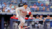 Sep 30, 2025; Bronx, New York, USA; Boston Red Sox third base Alex Bregman (2) hits a single during the first inning against the New York Yankees during game one of the Wildcard round for the 2025 MLB playoffs at Yankee Stadium. Mandatory Credit: Brad Penner-Imagn Images