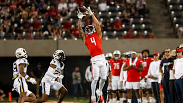 Oct 26, 2024; Tucson, Arizona, USA; Arizona Wildcats wide receiver Tetairoa McMillan (4) attempts to catch the ball during the third quarter against the West Virginia Mountaineers at Arizona Stadium.