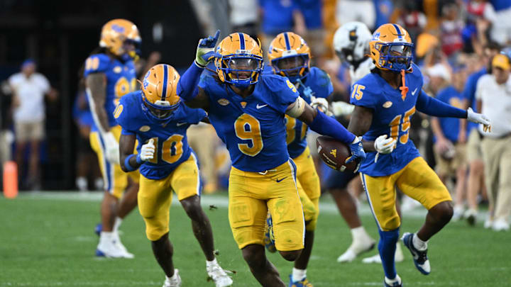 Sep 14, 2024; Pittsburgh, Pennsylvania, USA; Pittsburgh Panthers linebacker Kyle Louis celebrates after intercepting West Virginia Mountaineers quarterback Garrett Greene (6) in the fourth quarter at Acrisure Stadium. Mandatory Credit: Barry Reeger-Image Images