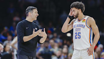 Oct 9, 2024; Oklahoma City, Oklahoma, USA; Oklahoma City Thunder head coach Mark Daigneault talks to guard Ajay Mitchell (25) during a break in play in the second half at Paycom Center. Mandatory Credit: Alonzo Adams-Imagn Images